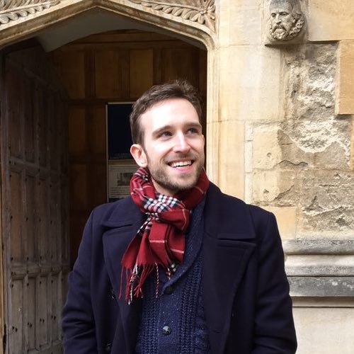 Photograph of Colin, looking incredibly content as he stands in front of the Bodleian Library in Oxford.
